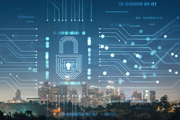 Illuminated Skyline panorama of Los Angeles downtown at night, California, USA. Skyscrapers of LA city. Glowing Padlock hologram. The concept of cyber security to protect confidential information