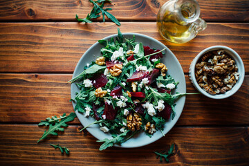 Arugula and beetroot salad with walnuts and feta cheese, top view