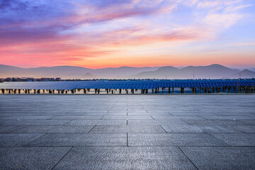 Empty square floor and solar power station at beautiful sunset. green energy concept.