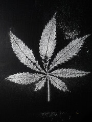 Cannabis leaf stencil white on black. flour. dust. grunge. Vertical