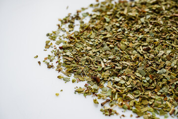 dried fragrant oregano marjoram on a white acrylic background