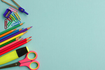 Fototapeta premium Top view of school supplies and office supplies on blue background. Learning, study, office equipment and presentation concept.