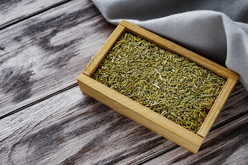 fragrant dried rosemary on a wooden rustic background