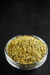 fragrant dried rosemary on a black stone background