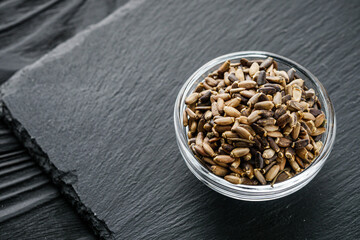 milk thistle seeds on a black wooden rustic background