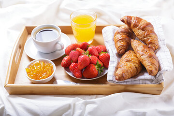 Breakfast in bed. Tray with cup of coffee, orange juice, fresh fruits