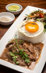 Traditional cambodian Lok Lak stir fried beef with rice meal