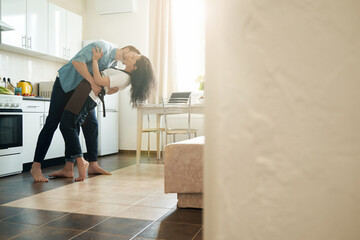 Passionate guy and his beloved woman in kitchen