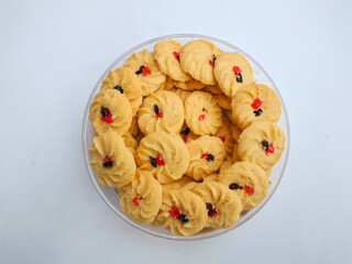 Cookies in a bowl. Sagu keju or kue sago or kue semprit keju with strawberry jam on top. Indonesian butter cookies. These cookies commonly served for Idul Fitri or Lebaran The Great Islamic Day