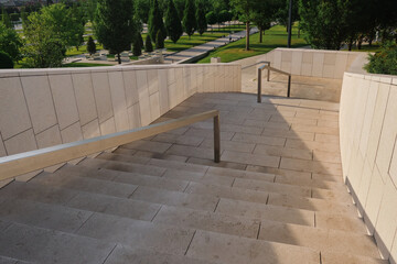 beige granite stairs in a modern park during the day