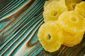 delicious dried pineapple on a wooden rustic background