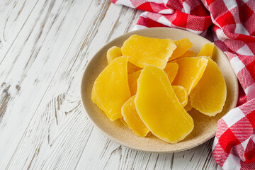 delicious dried mango on a white wooden rustic background