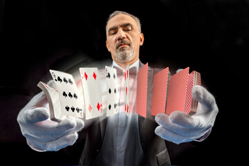 Magician with cards, Card manipulation, Croupier or casino dealer at gambling club or casino. Close...