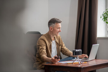 Man looking smiling at laptop screen