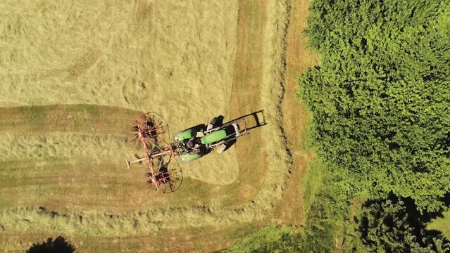DRONE VIEW OF A FARMER HARVESTING
A farmer is harvesting a field of wheat with his tractor to make hay for his livestock. June 2022 - Normandy / FRANCE.
