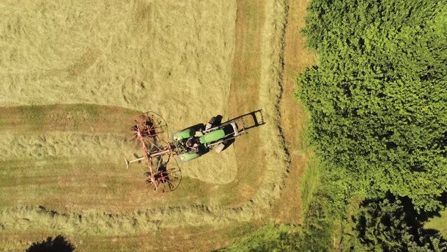 DRONE VIEW OF A FARMER HARVESTING
A farmer is harvesting a field of wheat with his tractor to make hay for his livestock. June 2022 - Normandy / FRANCE.
