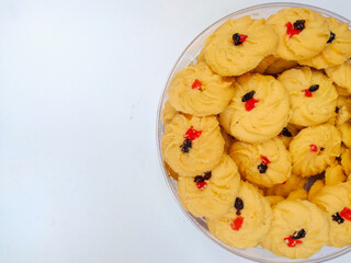 Cookies in a bowl. Sagu keju or kue sago or kue semprit keju with strawberry jam on top. Indonesian butter cookies. These cookies commonly served for Idul Fitri or Lebaran The Great Islamic Day.