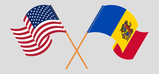 Crossed and waving flags of the USA and Moldova