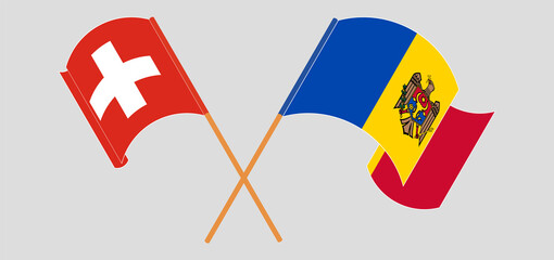 Crossed and waving flags of Switzerland and Moldova