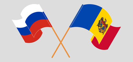 Crossed and waving flags of Russia and Moldova