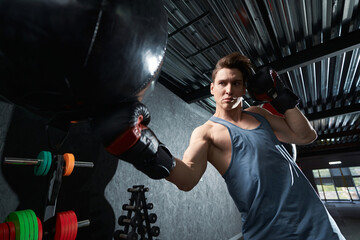 Strong muscular guy working out at gym