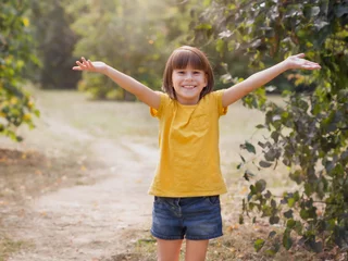  Young child arms raised up to sky, celebrating freedom. Positive children emotions. Free smiling girl in summer forest enjoying nature. Happy life concept © Albert Ziganshin