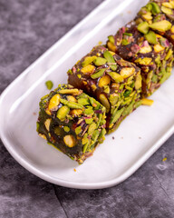 Turkish Delight with Pistachio on a dark background. Traditional Turkish delicacies. Turkish Delight with Apple Flavored Pistachio. close up