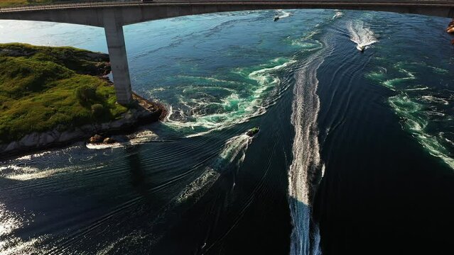 Aerial view of a boats driving through the Saltstraumen maelstrom in Norway - pan, drone shot