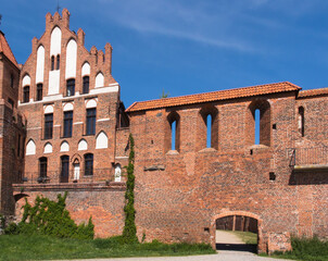 View of the old city gate and Gothic brick defensive walls in the historic city center of Torun