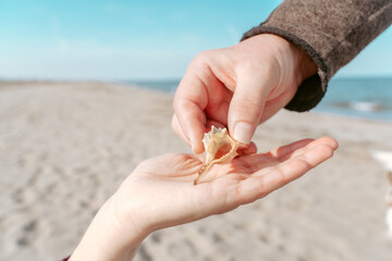 Man giving a gift to a woman at the seaside