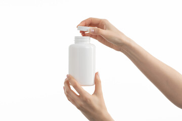 Close up image of woman holding a white bottle