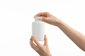 Close up image of woman holding a white bottle