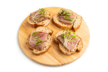 Bread sandwiches with jerky salted meat, sorrel and cilantro microgreen isolated on white. side view.