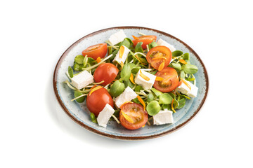 Vegetarian salad of tomatoes, marigold, microgreen, feta cheese isolated on gray. Side view.