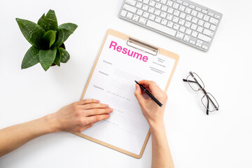 Employer reviews resume application form on office table