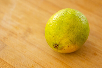 lime and avocado close up in wooden board