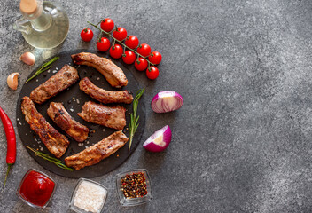 grilled pork ribs on a stone background with copy space for your text