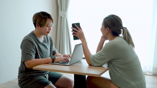 4K, This female couple, He lets his lover look at something on his cell phone, His lover nodded, and the other seemed pleased, put his hand on his cheek, The love, and friendship of LGBTQ couples.