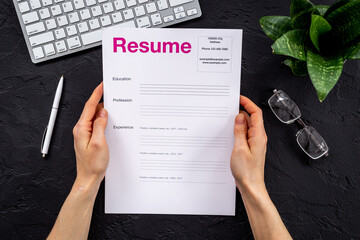 Job seeker or HR manager review resume on office table