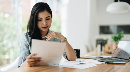 Fototapeta premium Business woman using calculator for do math finance on wooden desk in office and business working background, tax, accounting, statistics and analytic research concept