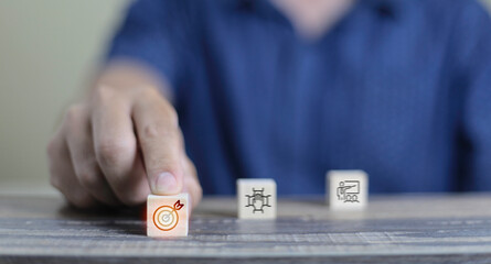 Businessman hand arranging wood block with icon business strategy