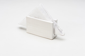 White ceramic napkin holder, with napkin inside, isolated on white