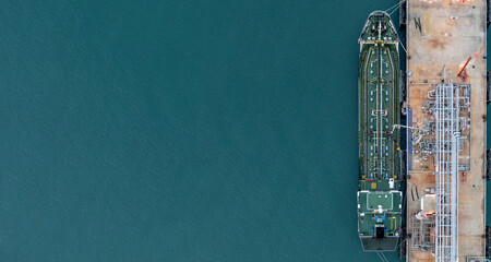 Aerial top view oil tanker ship at oil terminal industrial port for transfer crude oil to oil...