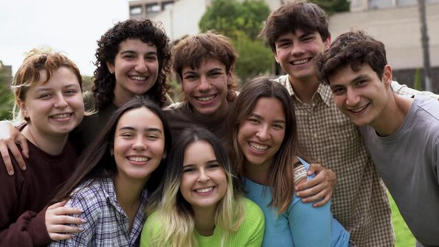 Diverse young people smiling on camera outside of university	
