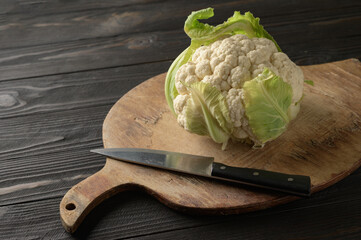Fresh whole cauliflower on wooden rustic background, top