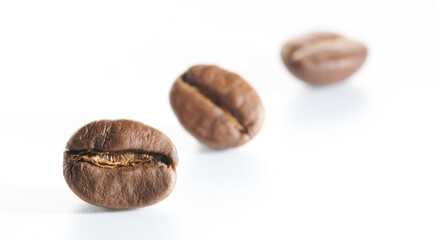 Roasted coffee beans isolated close up on white background, clipping path