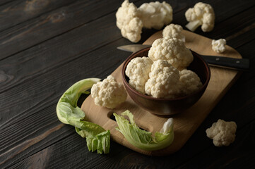 Raw, fresh organic cauliflower on a wooden background. Healthy eating, low carb diet concept