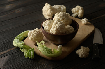 Raw, fresh organic cauliflower on a wooden background. Healthy eating, low carb diet concept