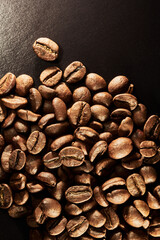 Roasted coffee beans isolated close up on black background, clipping path