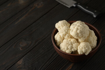 Raw, fresh organic cauliflower on a wooden background. Healthy eating, low carb diet concept